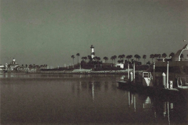 A harbor and lighthouse across still water