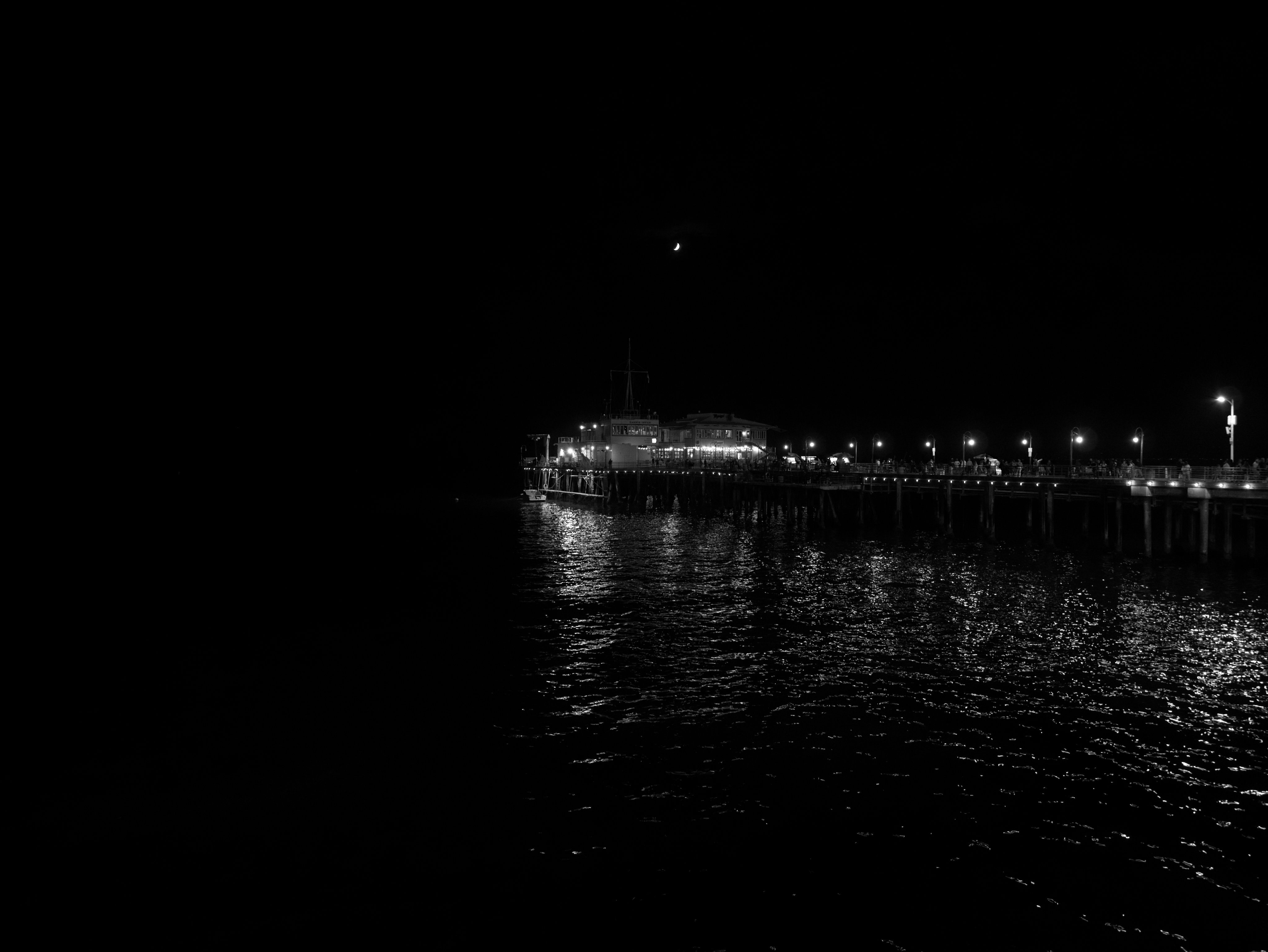 Pier lights reflected on dark water