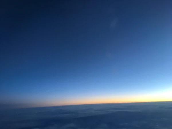 Sunrise along the horizon from a plane window