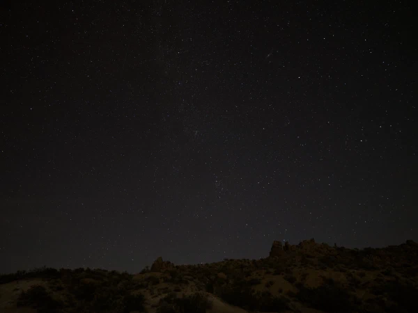 Stars over a dark desert ridge