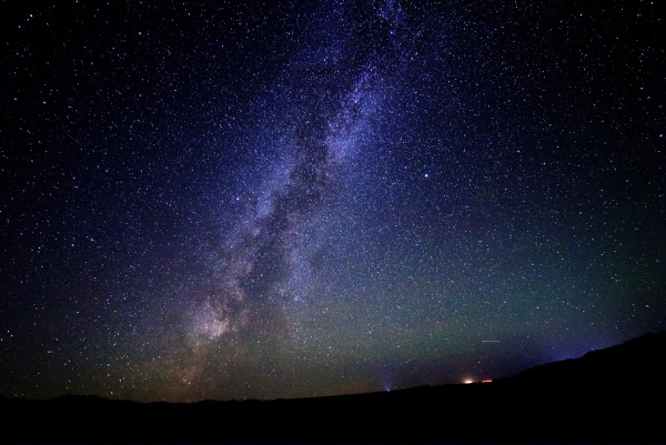 The Milky Way rising over a dark horizon