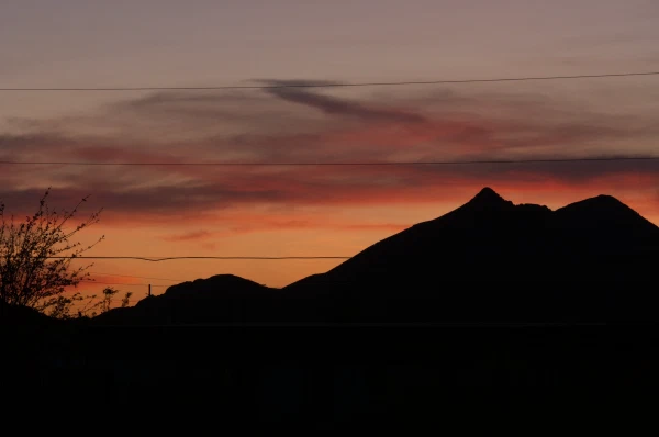 Mountain silhouette against an orange sunset