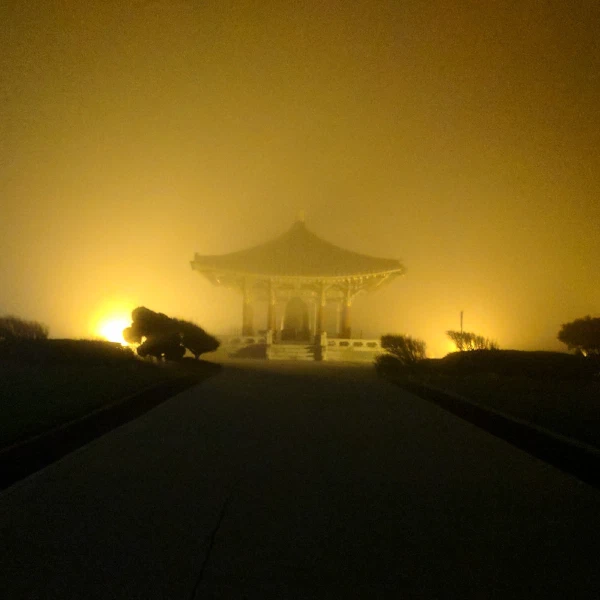 A gazebo glowing in yellow fog