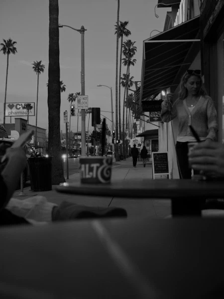 A sidewalk scene in black and white