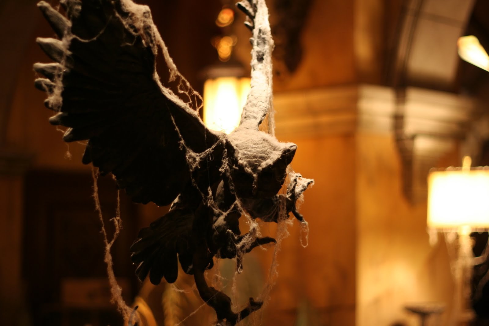 An owl with spread wings in warm lamplight at Disneyland